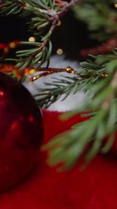 Vertical video. Small Christmas decorations, berries, and cinnamon sticks for fragrance are placed