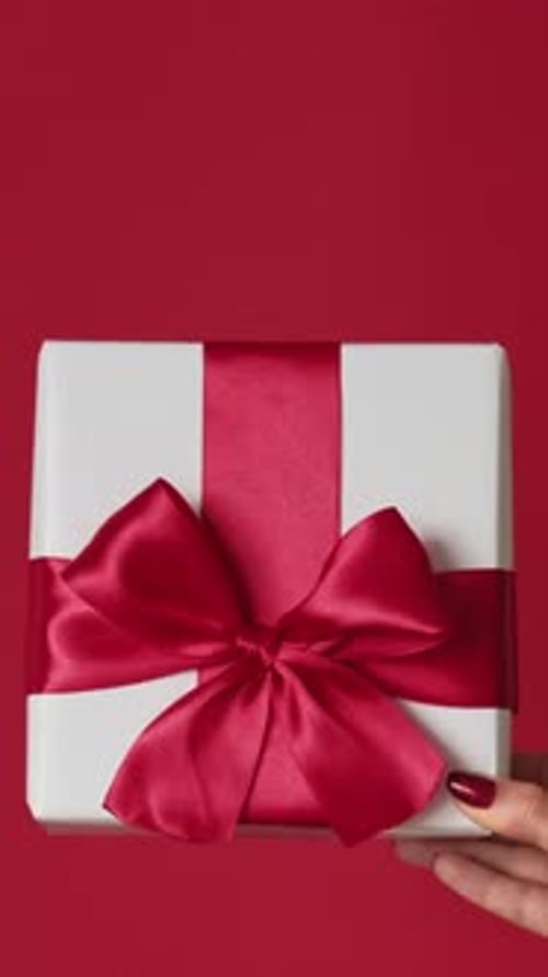 Gift box held with nail polished hand