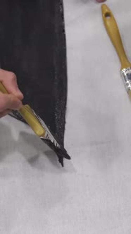 Hand Painting with Brush Applying Black Paint