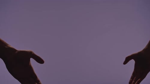 Man and Woman Hands Showing Gestures and Making Heart Love Hand Sign Isolated on Purple Studio