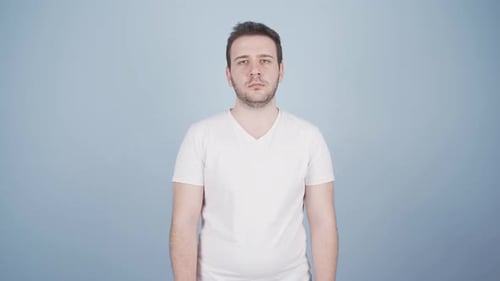 Man Expressing Surprise in White T-Shirt