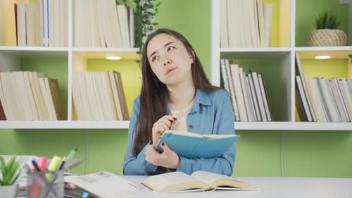 Young Woman Studying with Books at Home