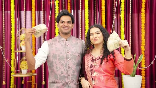 Indian Couple using Money as Fan