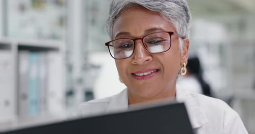 Smiling Woman Wearing Eyeglasses and White Coat