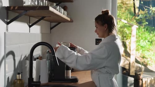 Woman Making Coffee in Bright Kitchen in the Morning