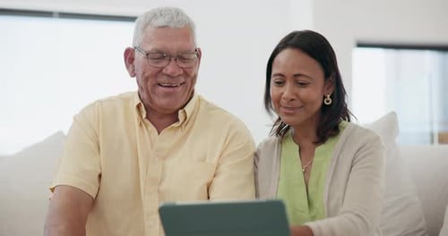 Senior Couple Using Tablet Together at Home