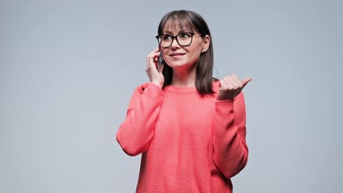 Woman Gesturing and Talking on Mobile Phone