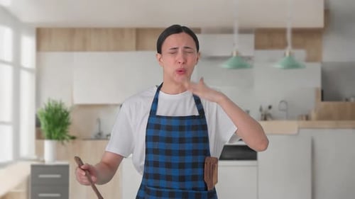 Indian housewife tasting spicy food