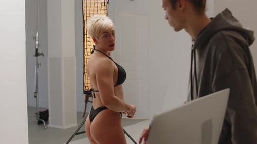 Fitness Bikini Model Making Poses while Shooting in Photo Studio