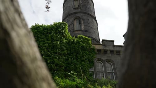 Tilt up push in through tree branches to historic building nelson monument Scotland