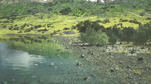 Chilly Mountainous Lake with Subdued Colors and Dramatic Sky