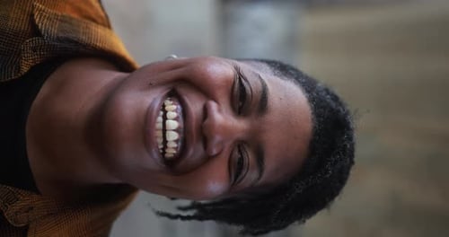 Smiling young woman, curly hair, portrait orientation