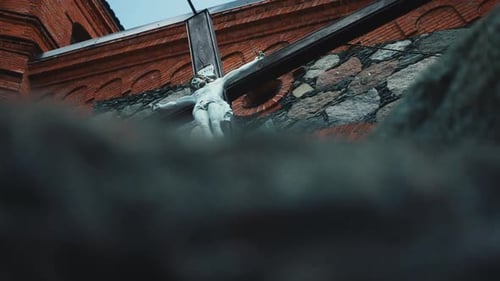 Great stone cathedral building with jesus christ on cross in ancient gothic style