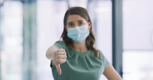 Business woman, face mask and thumbs down for no, rejection or refusal and disagree at office