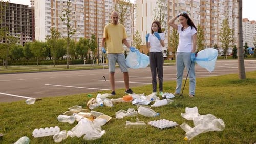 Family Volunteers Cleaning Urban Green Space