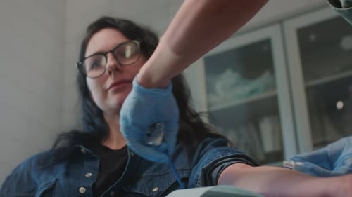 Woman Receiving Medical Care in Bright Clinic