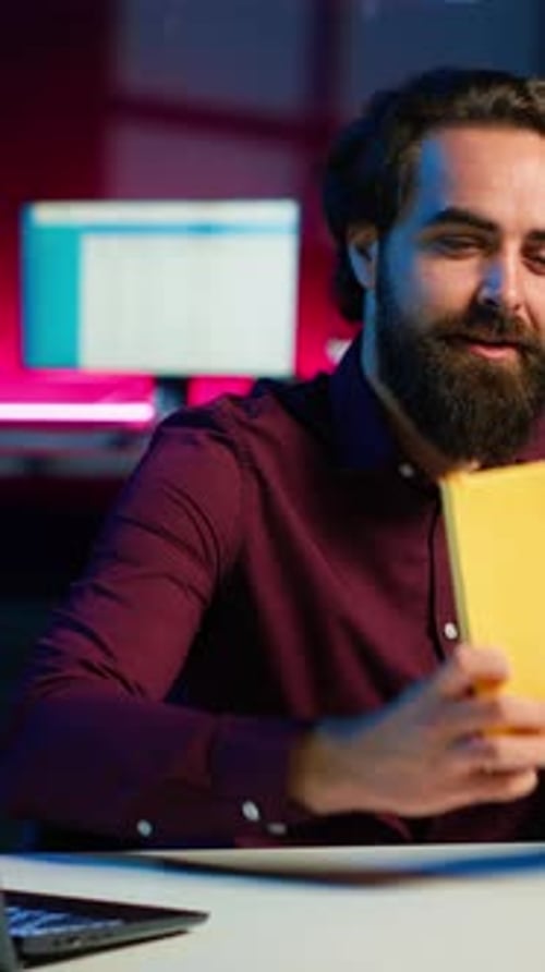 Vertical Video Cheerful Content Creator in Studio Reviewing Newly Released Hardcover Book
