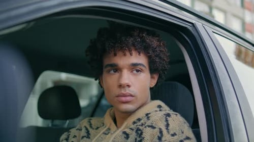 Young Driver Sitting Car Steering Wheel Looking Through Window on City Closeup