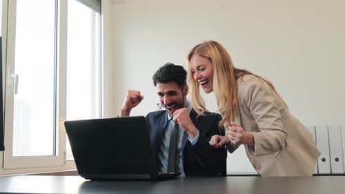 Successful Team Celebrate Business Win in Office