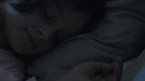 Peaceful Child Sleeping Soundly in Bed at Night