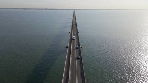 aerial footage hovering over the enormously long Zeeland bridge and the traffic over the highway on