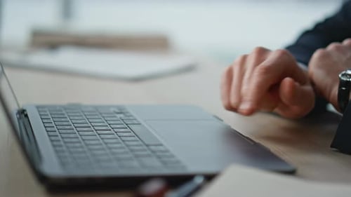 Manager Hands Using Touchpad Laptop at Office Workspace Focused on Task Closeup