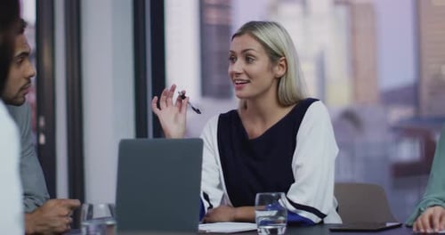 Video of caucasian businesswoman talking to colleagues at office meeting
