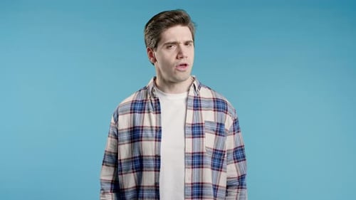 Man Posing in Front of a Blue Background