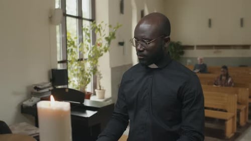 Priest Praying in Church