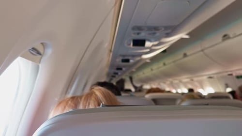 Airplane interior with passengers in their seats