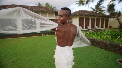 Fashionable Individual in White Gown Smiling