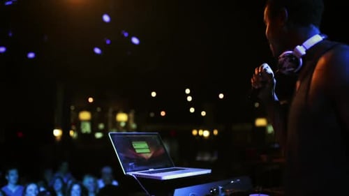 DJ Performs on Stage in Front of Audience