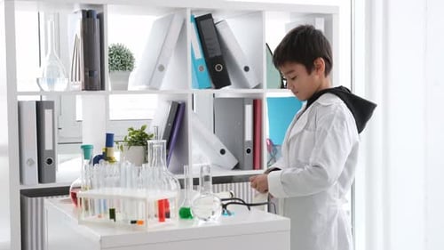 Child Scientist Putting on Gloves in a Lab