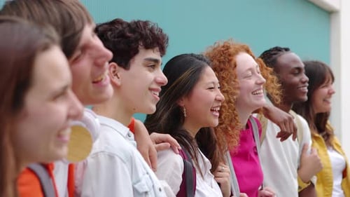 Multiethnic Group of College Student Friends Posing Over Blue Background