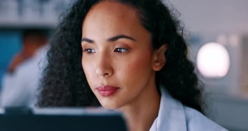 Woman Researcher Working on Tablet in Modern Lab