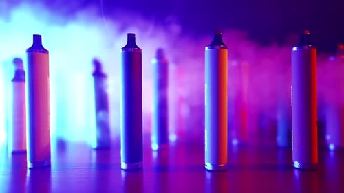 Illuminated Vapes in Smoky Neon Light