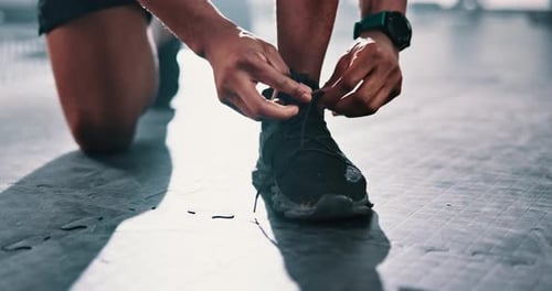 Closeup, gym or hands of person with shoes for training, exercise or workout routine in fitness
