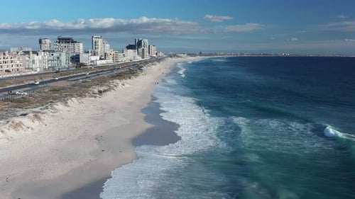 Aerial View Of Buildings And Blouberg Beach On A Sunny Summer Day - drone shot