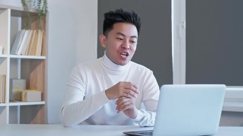 Adult having a cheerful video conference on laptop