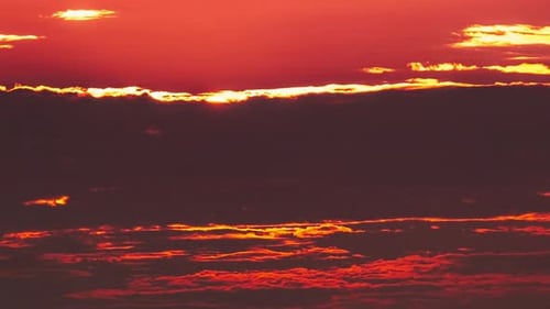 Timelapse Dramatic Sunset with Sun Rays in the Sky Through Orange Layered Clouds