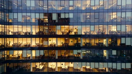 LateNight Hustle Drone's Cinematic View of Office Workers in Glass Skyscrapers