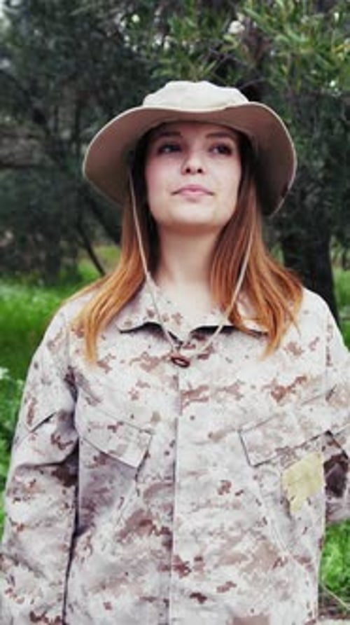 Woman in Army Uniform Salutes in Nature