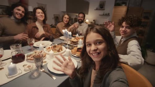 Family Celebrates Holiday at Festive Dinner Table