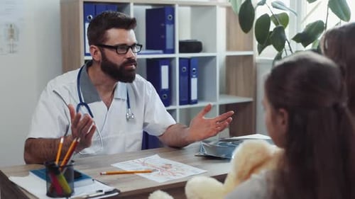Doctor Explaining Diagnosis to Child Patient and Mother