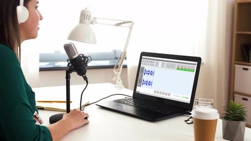 Woman Recording Podcast Using Microphone and Laptop