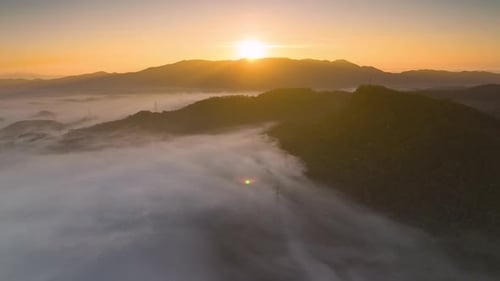 Aerial view Beautiful of morning scenery Golden light sunrise And the mist flows on high mountains.