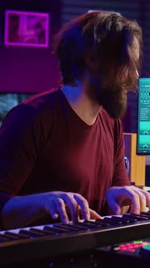 Young Adult Playing Keyboard in a Music Studio