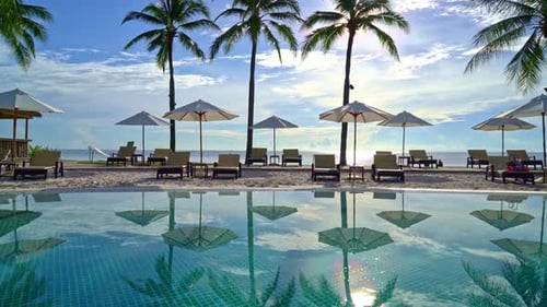 Beautiful umbrella and chair around swimming pool in hotel and resort - vacation concept