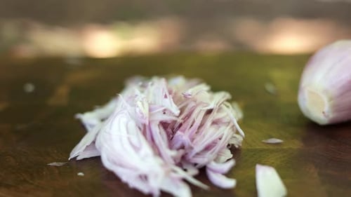 Chopping Red Onions on a Wooden Cutting Board