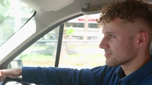 Happy Man Feeling Comfortable While Sitting on Driver Seat in His New Car Looking on the Road Right